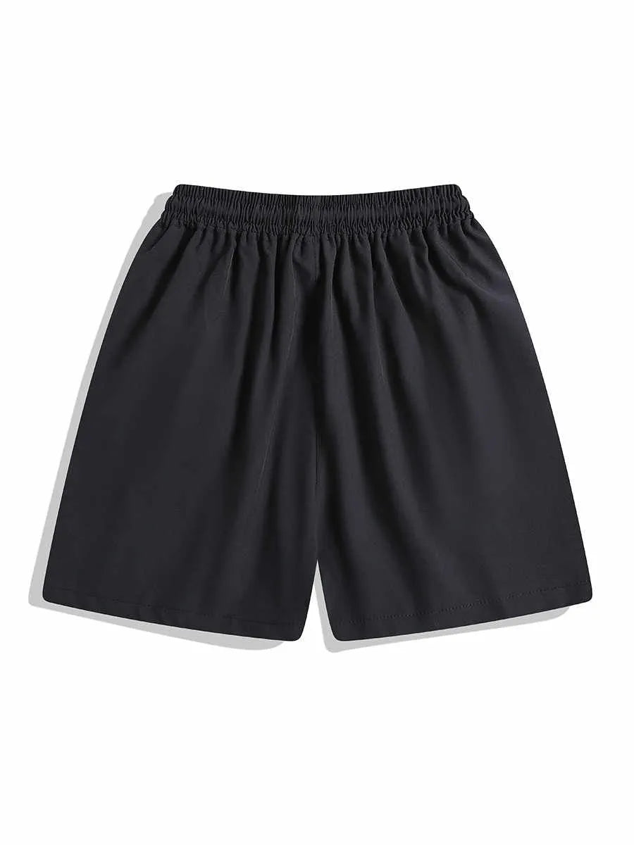 Man wearing loose black quick-drying sports shorts with an elastic waist for training.