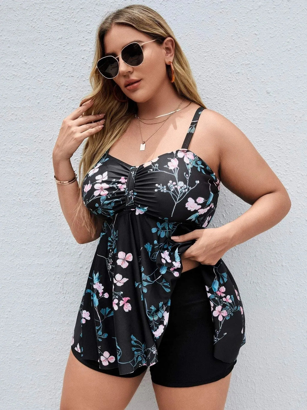 Women's one-piece swimsuit with a split colour floral print, shown in an extended size.