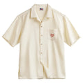 Light apricot men's shirt with a bamboo and floral pattern and a Cuban collar.