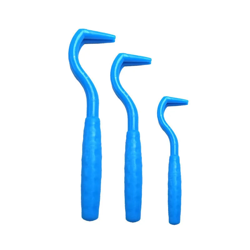 Set of three coloured tick hook removers for dogs on a white background.