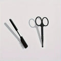 Black pet grooming brush with soft silicone bristles and a built-in comb for dogs and cats.