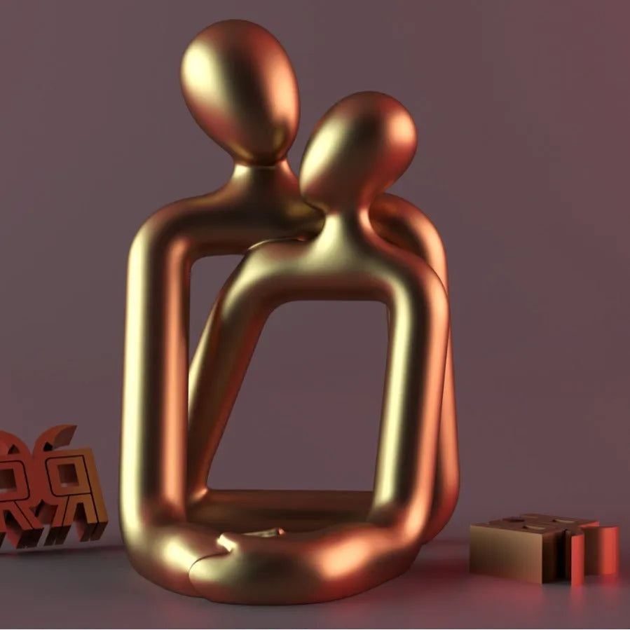 Modern minimalist loving couple resin statue in Gold or Milky White finish on a wooden surface.