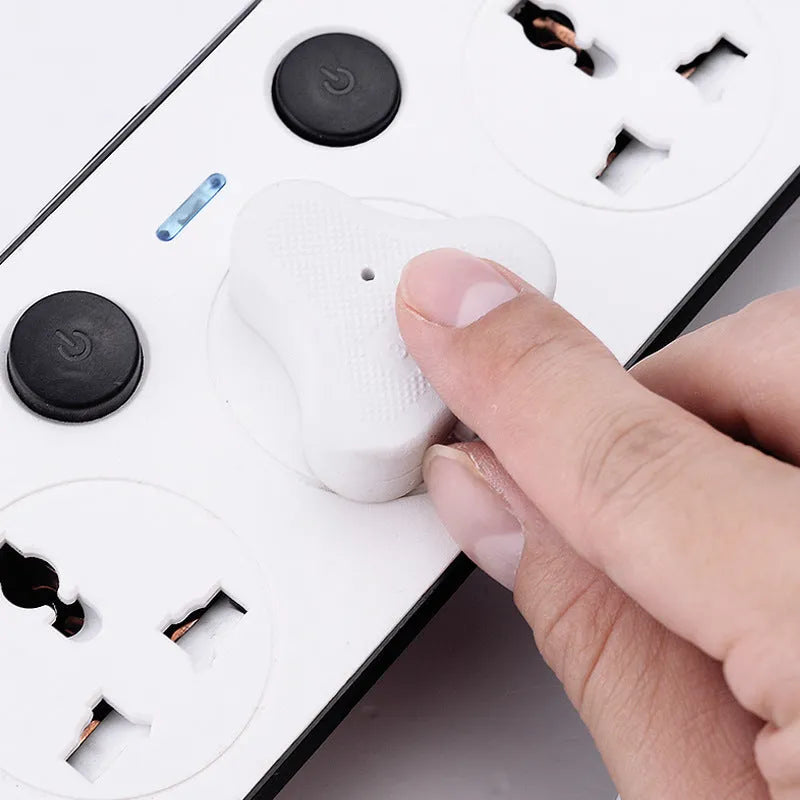 Multi-switch power strip with international sockets, USB ports, and a long cable on a desk.