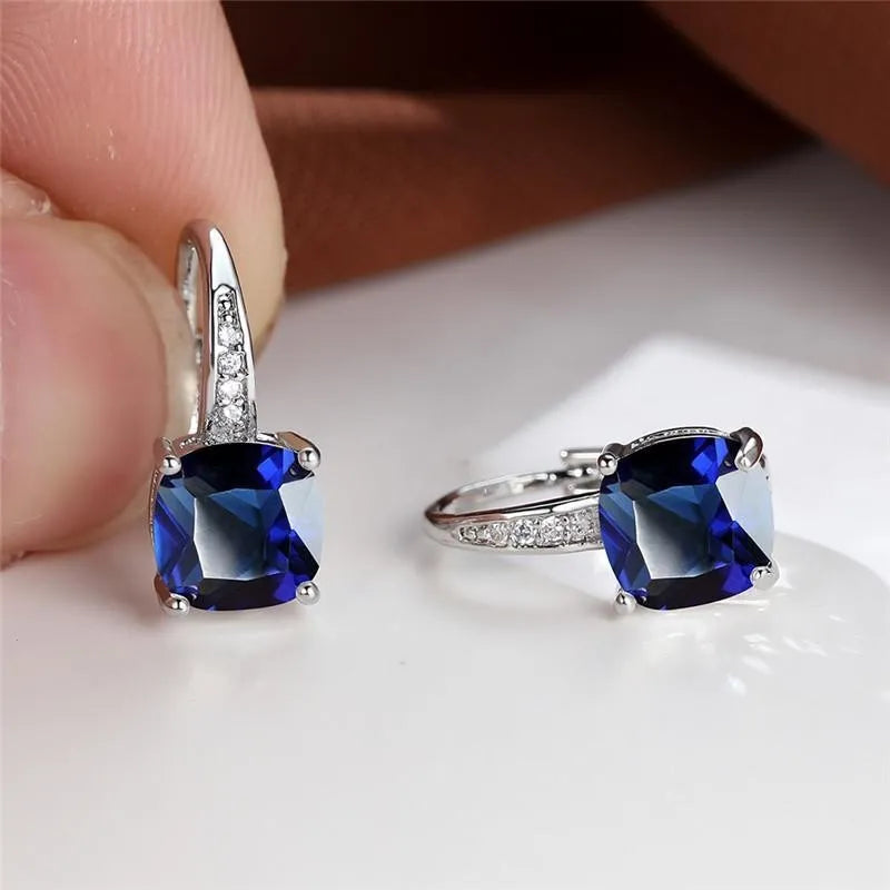 Square geometric ear hook earrings with zircon stones in an electroplated copper setting.
