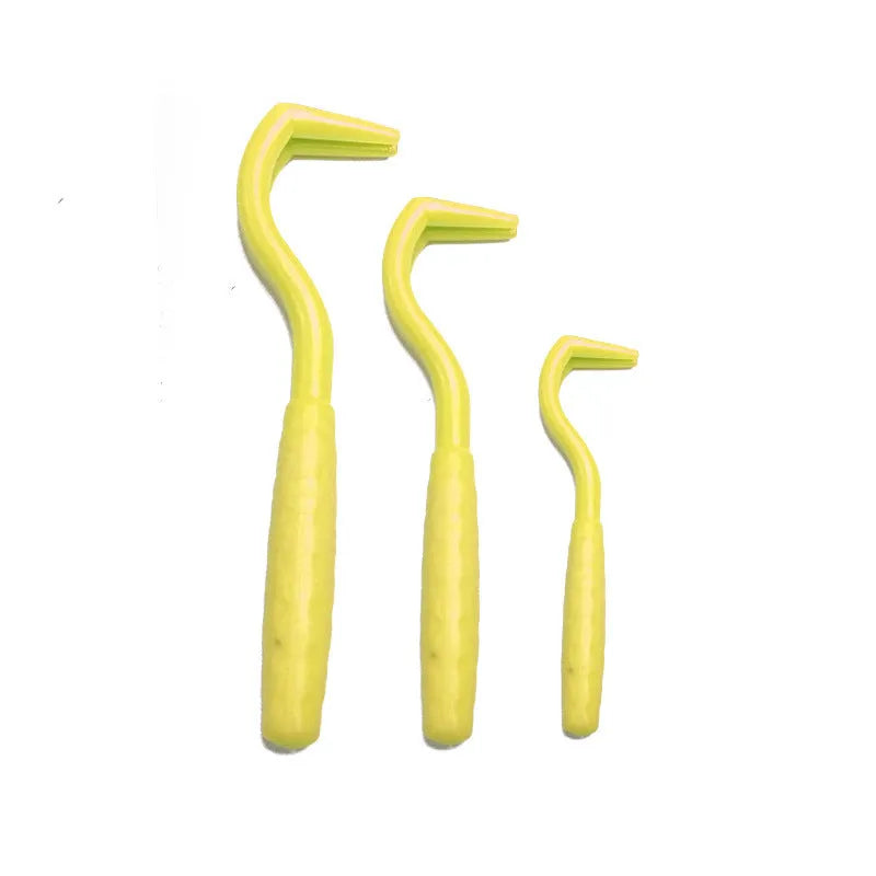 Set of three coloured tick hook removers for dogs on a white background.