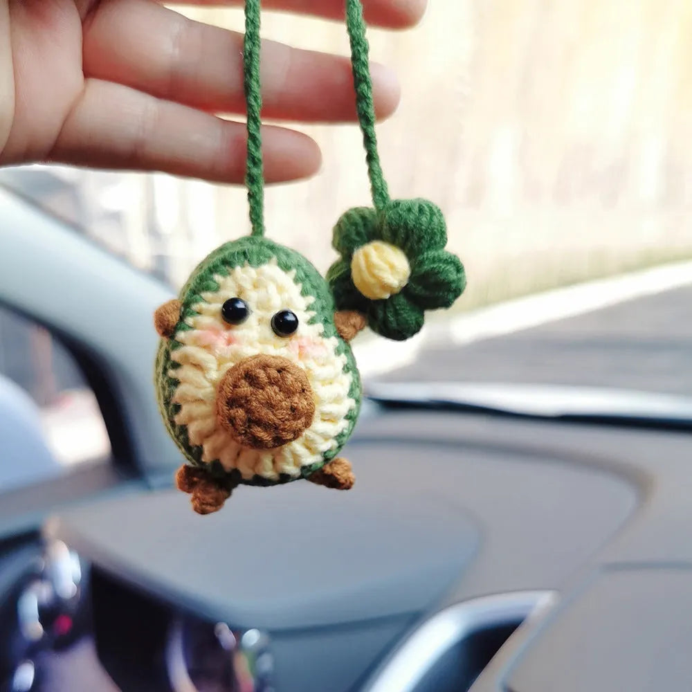 Handmade crocheted wool car pendant with rainbow colours hanging from car mirror