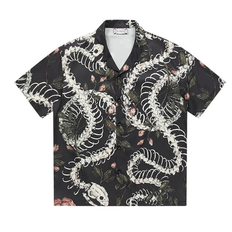 Short sleeve loose fit shirt with snake bone and floral pattern print and a Cuban collar.