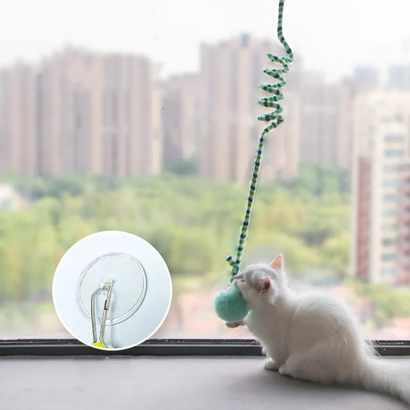 Hanging cat toy with bell stick and inflatable ball attached to door with suction cup