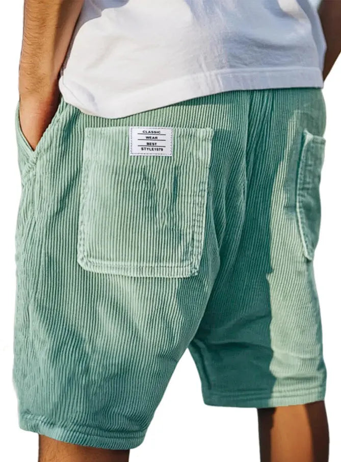 Men's grey corduroy shorts with multiple pockets and embroidery detail on leg, laid flat.