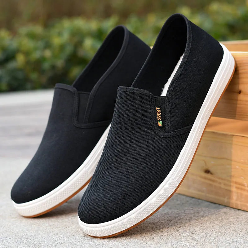 Men's black canvas slip-on shoes with round toe and low-top design