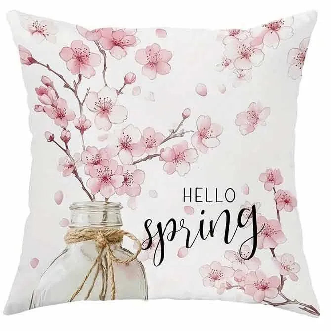45cm square cherry blossom print cushion cover in short velvet fabric on a grey sofa.