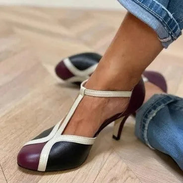 Women's round toe high heel shoe with button fastening in light blue and pink colour combination.