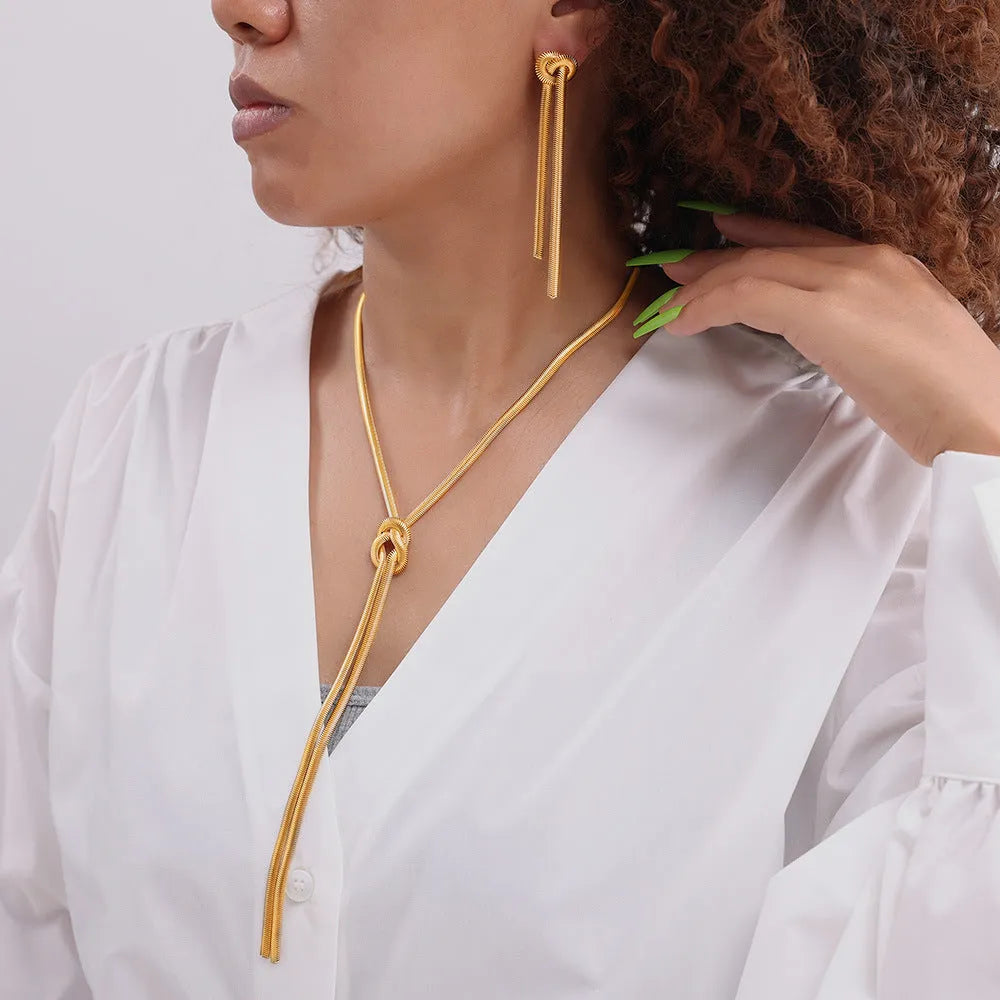 Gold electroplated titanium steel necklace and earrings set with snake chain and knotted tassel design