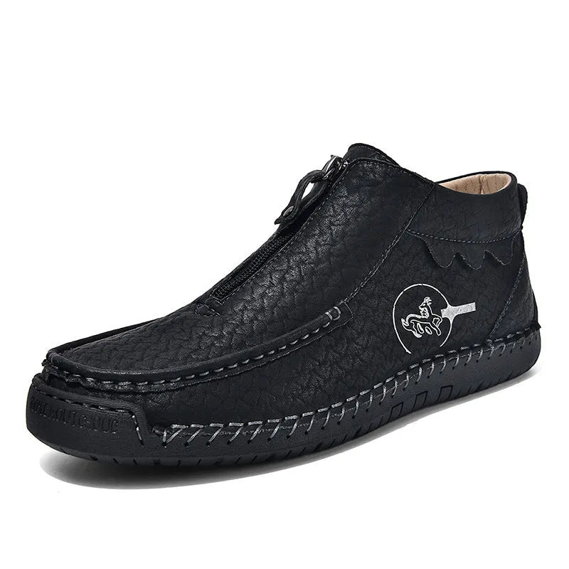 Men's black slip-on leather loafers with round toe and stitching detail on a solid colour background.