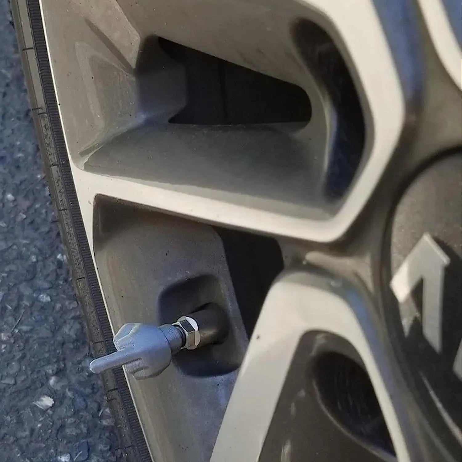 Eight car tyre valve dust caps showing four black and four skin colour latex pieces