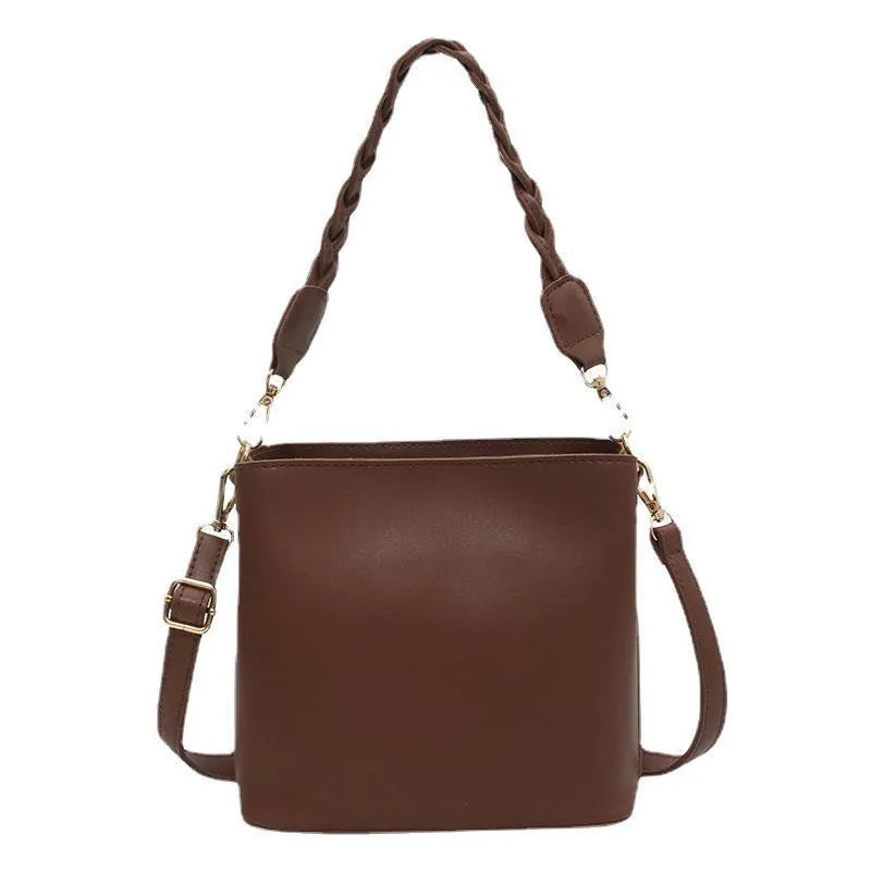 Khaki PU leather crossbody bucket bag with weaving texture and single shoulder strap.