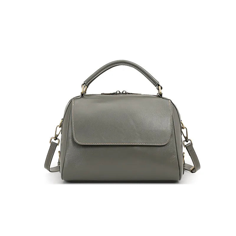 Women's genuine leather crossbody tote bag in apricot colour showing internal compartments and shoulder straps.