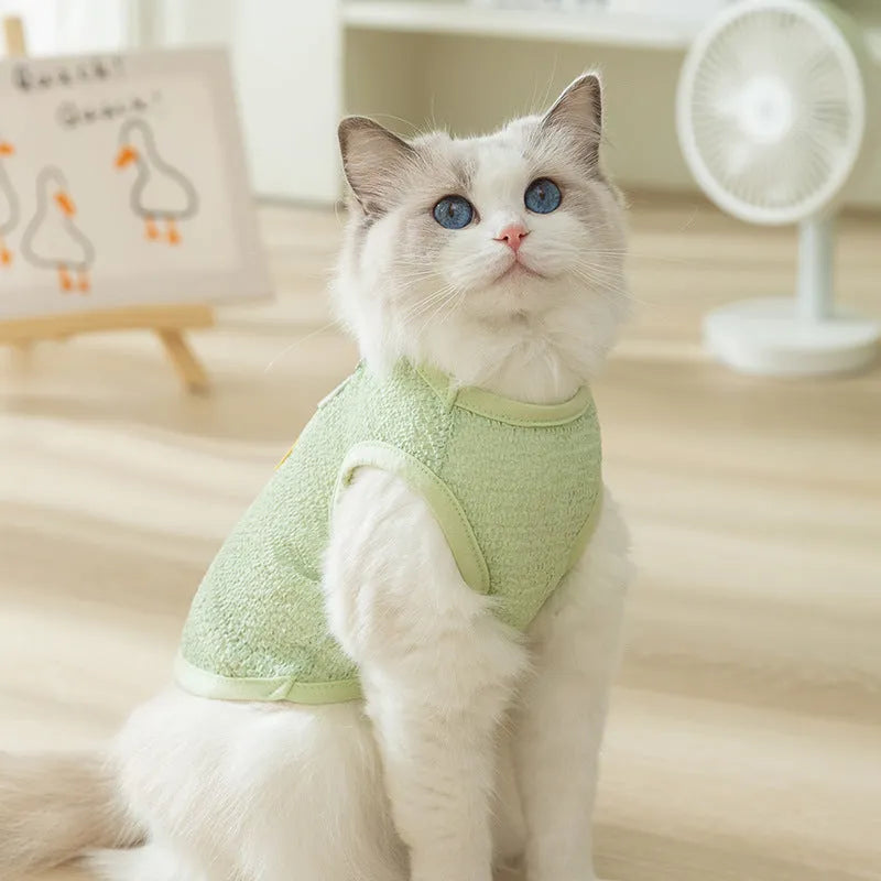 Green knitted cat clothes with bear patch showing hollowed-out breathable design