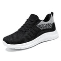 Women's low-top black mesh sneakers with round toe and white PVC sole, shown with lace-up front.