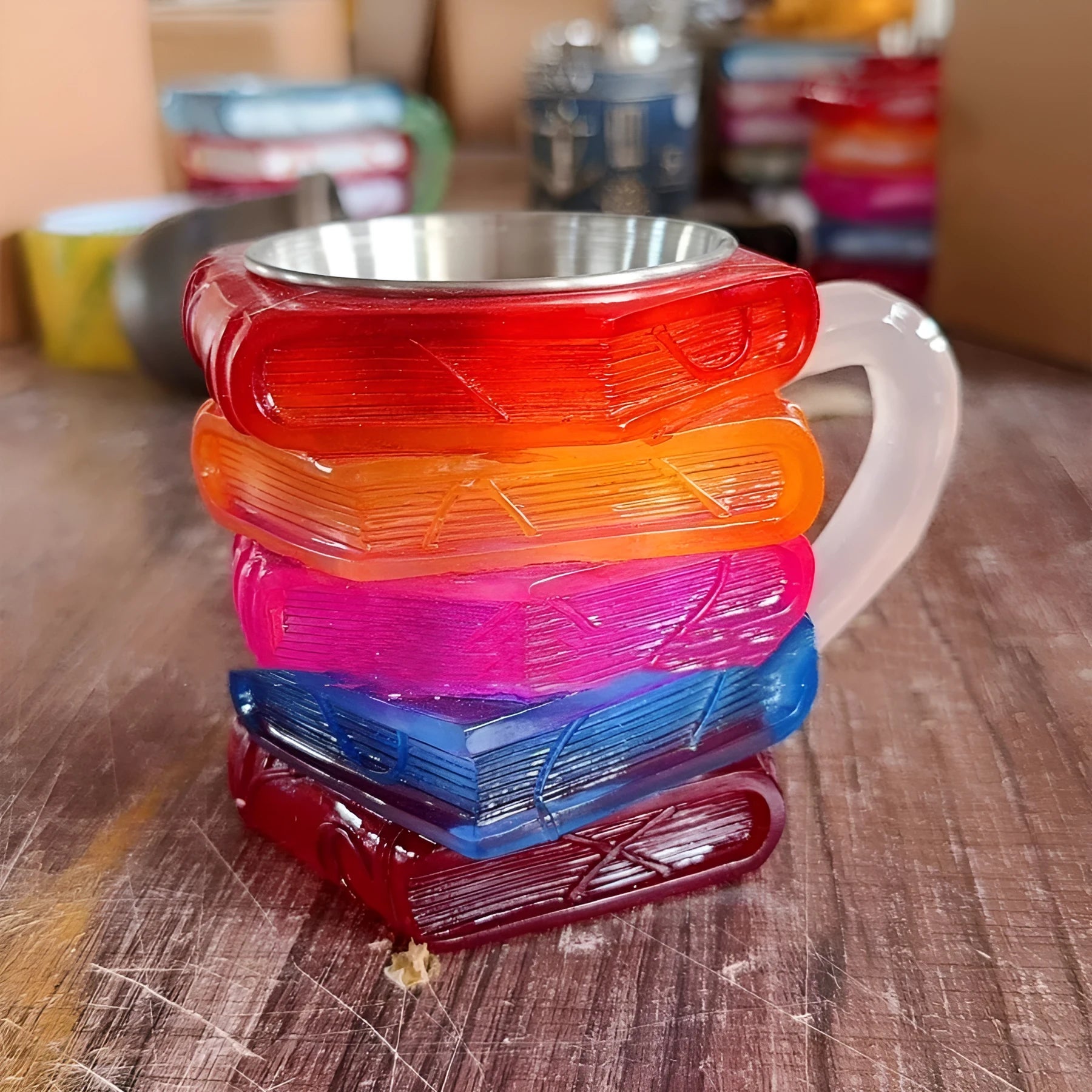 Synthetic resin decorative coffee cup ornament with painted book design.