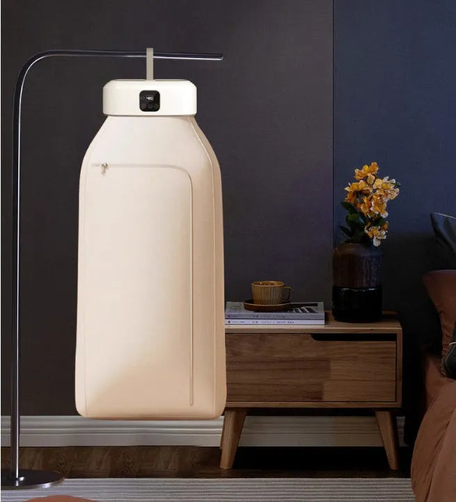 White cylindrical compact laundry dryer with remote control for small space drying