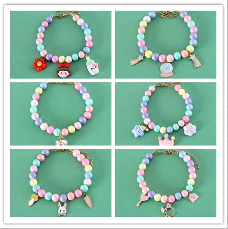 Macaron-coloured resin pet collar and bracelet set for birthday photoshoots on a neutral background.