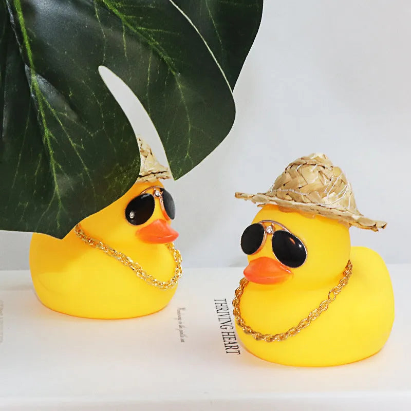 Yellow duck cartoon character wearing straw hat car dashboard ornament with sunglasses and necklace accessories