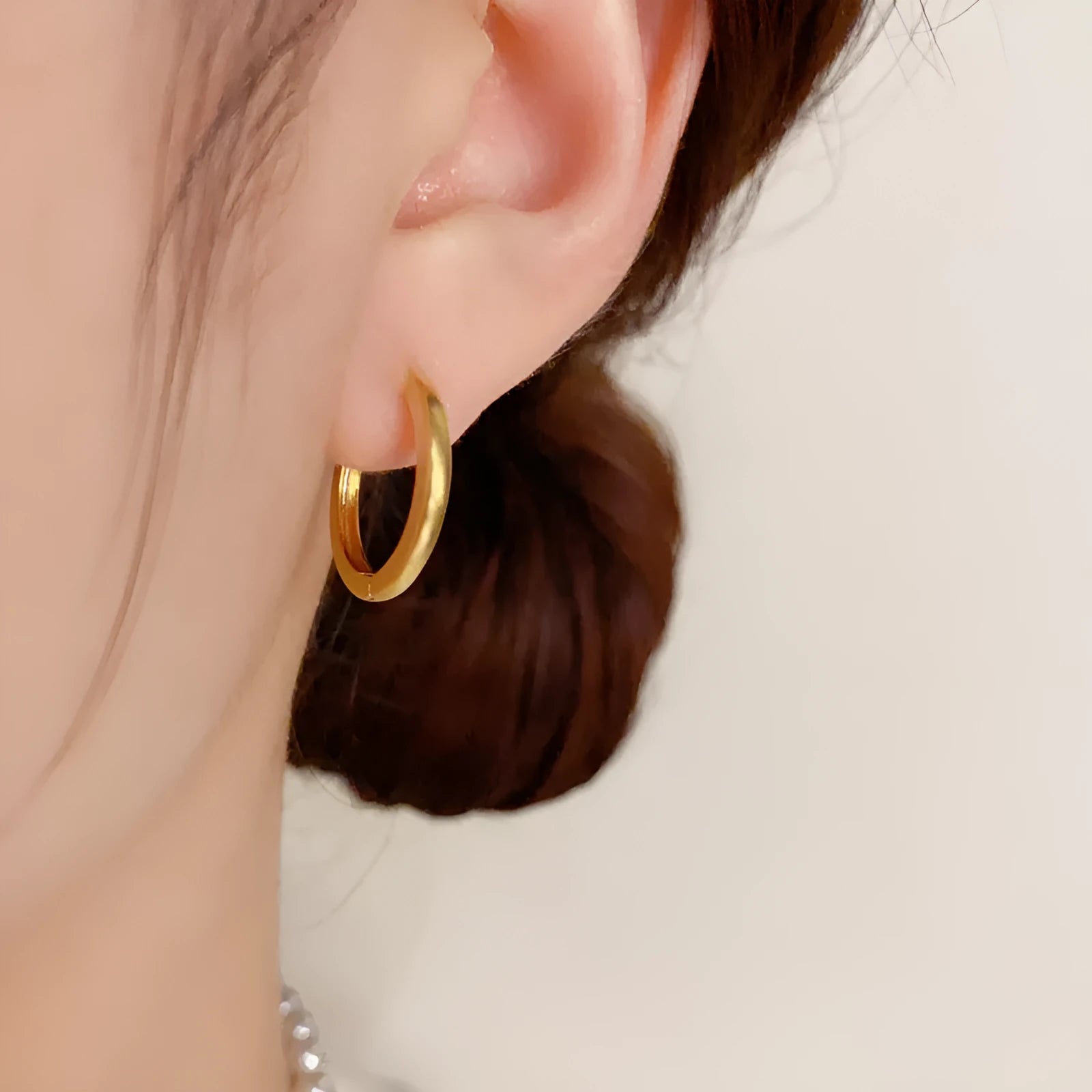Geometric gold or silver-plated ear clip with round eyelet detail for women