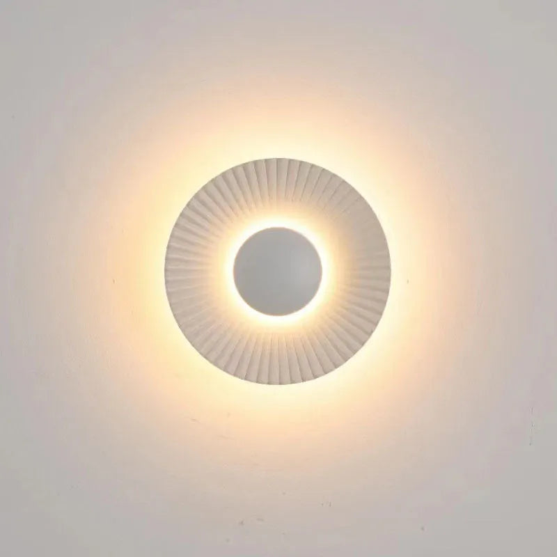 Round aluminium wall lamp with LED light in a choice of colour finishes including white and gold.