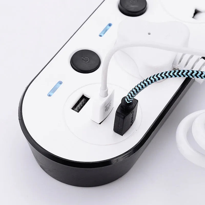 Multi-switch power strip with international sockets, USB ports, and a long cable on a desk.