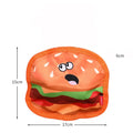 Colourful crinkle and squeaky dog chew toys shaped like a hamburger, fries, a hot dog, and a pizza on a plain background.