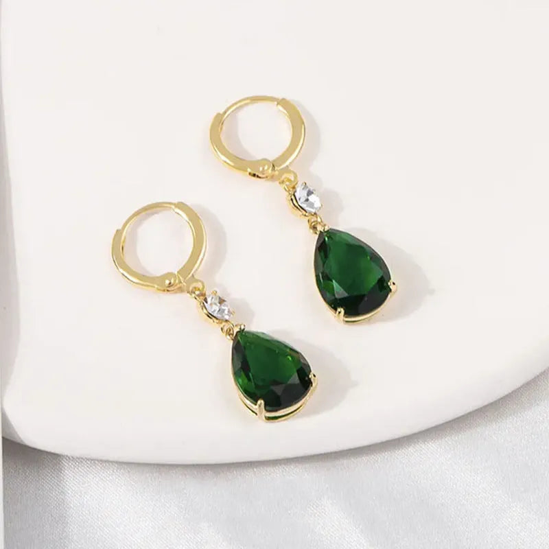 Green geometric teardrop earrings with alloy construction showing structured patterning