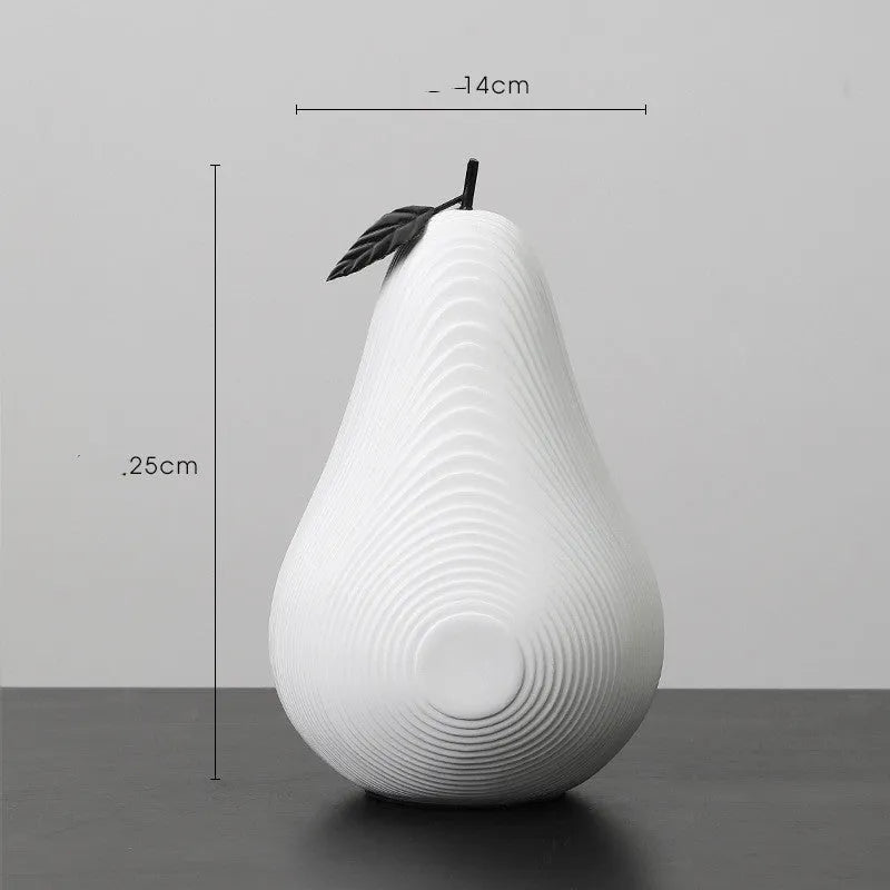 Resin decorative sculptures of apples and pears in black, white, orange and blue colours.