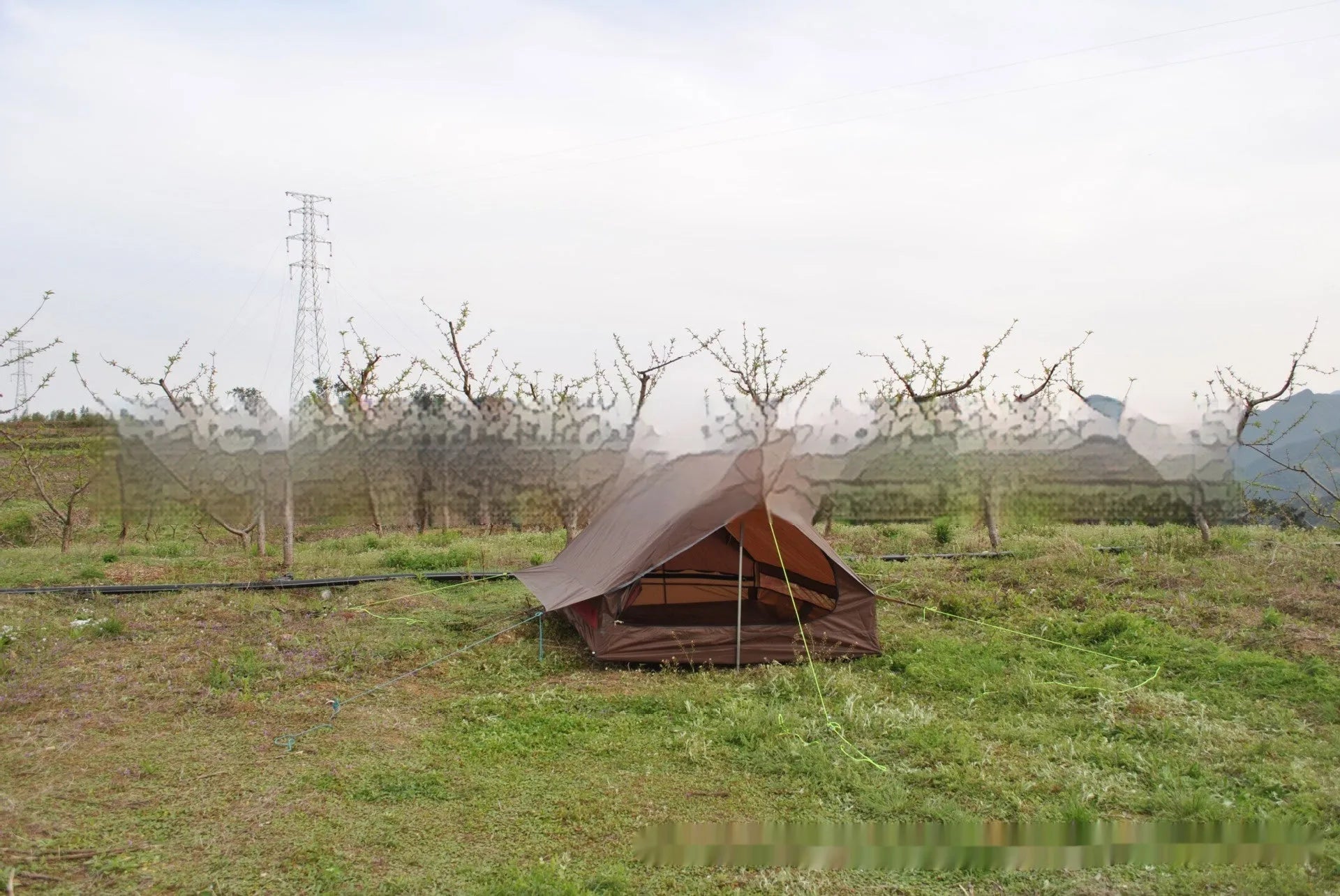 Brown or white A-line cabin tent pitched with trekking poles, showing spacious interior and waterproof fabric construction