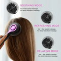 Grey head massage tingler with built-in hair brush, showing mechanical buttons and USB port.