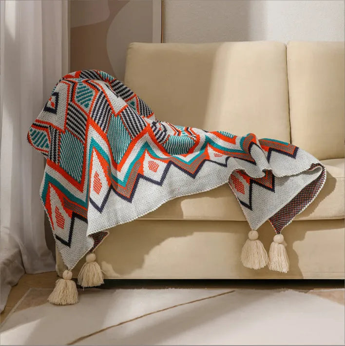Bohemian-style acrylic sofa blanket with tassel edges in geometric pattern or solid colour options