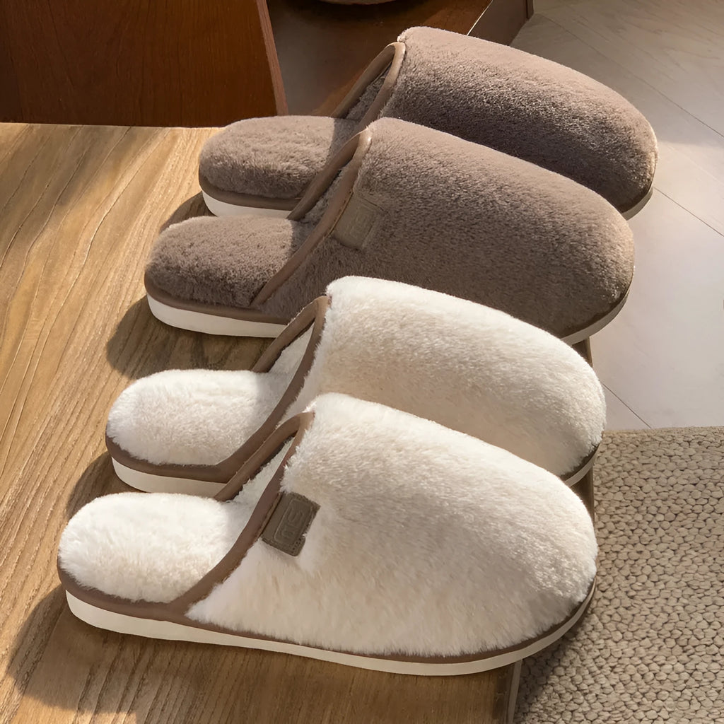 Solid colour PVC plush slippers with non-slip sole and car stitching detail on a wooden floor.