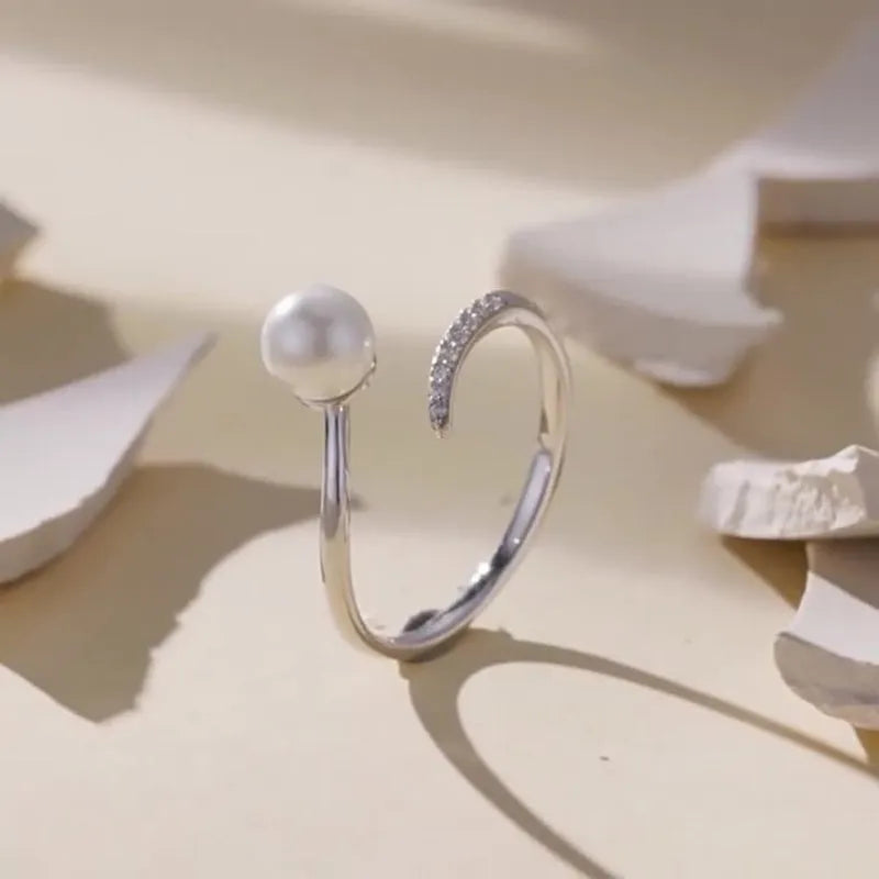 Sterling silver adjustable ring with freshwater pearl on open-loop design