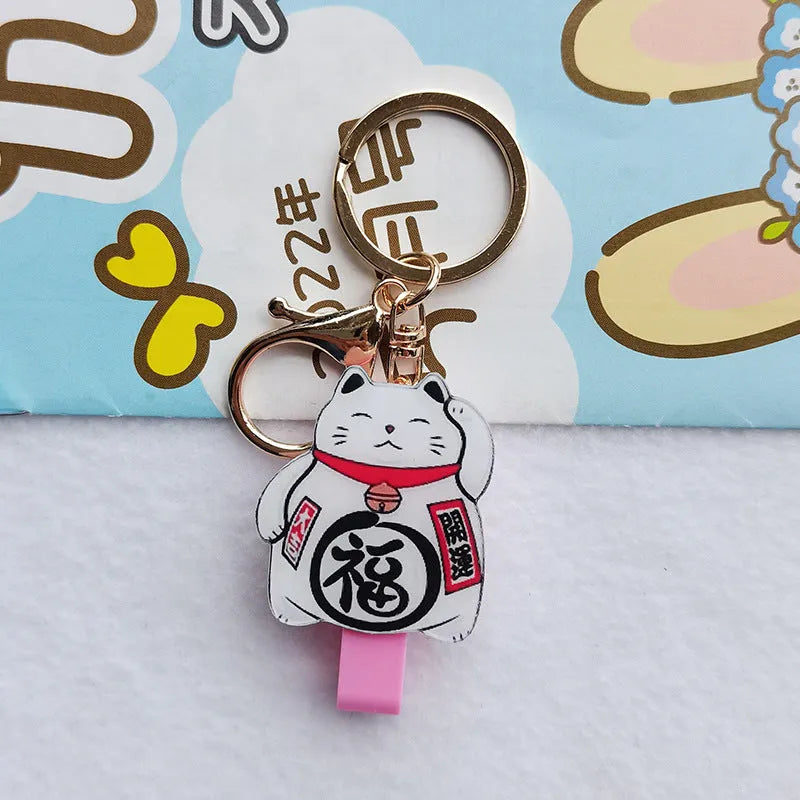 Lucky Cat blessing certificate set showing plastic card sleeve and ferrule pendant in cartoon style.