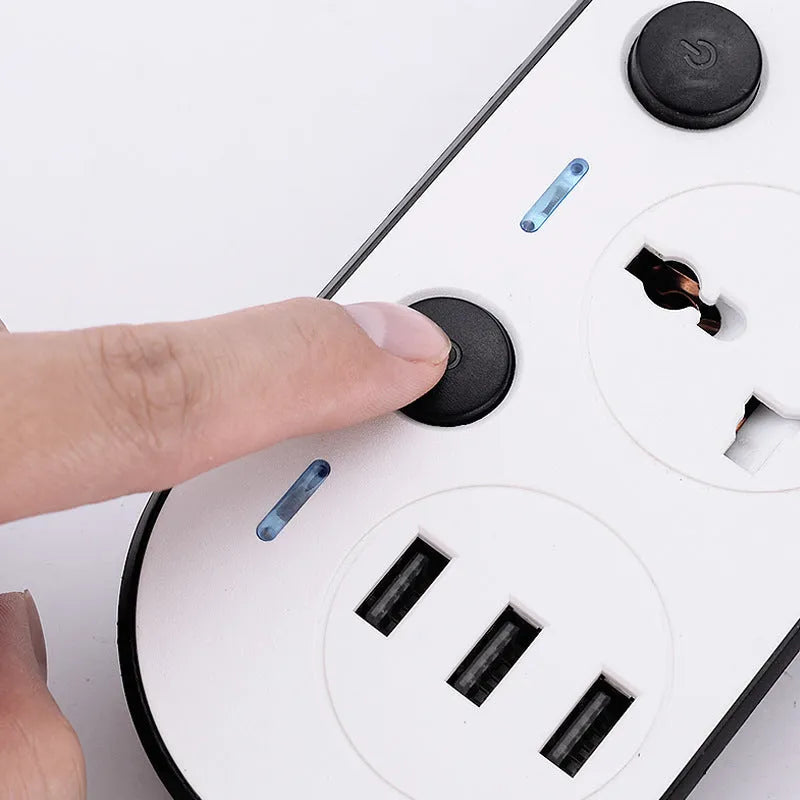 Multi-switch power strip with international sockets, USB ports, and a long cable on a desk.