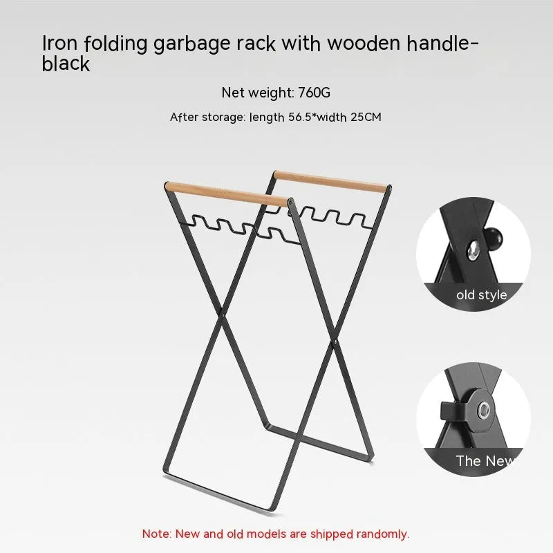 Black folding iron trash rack with wooden handles holding a bin bag outdoors