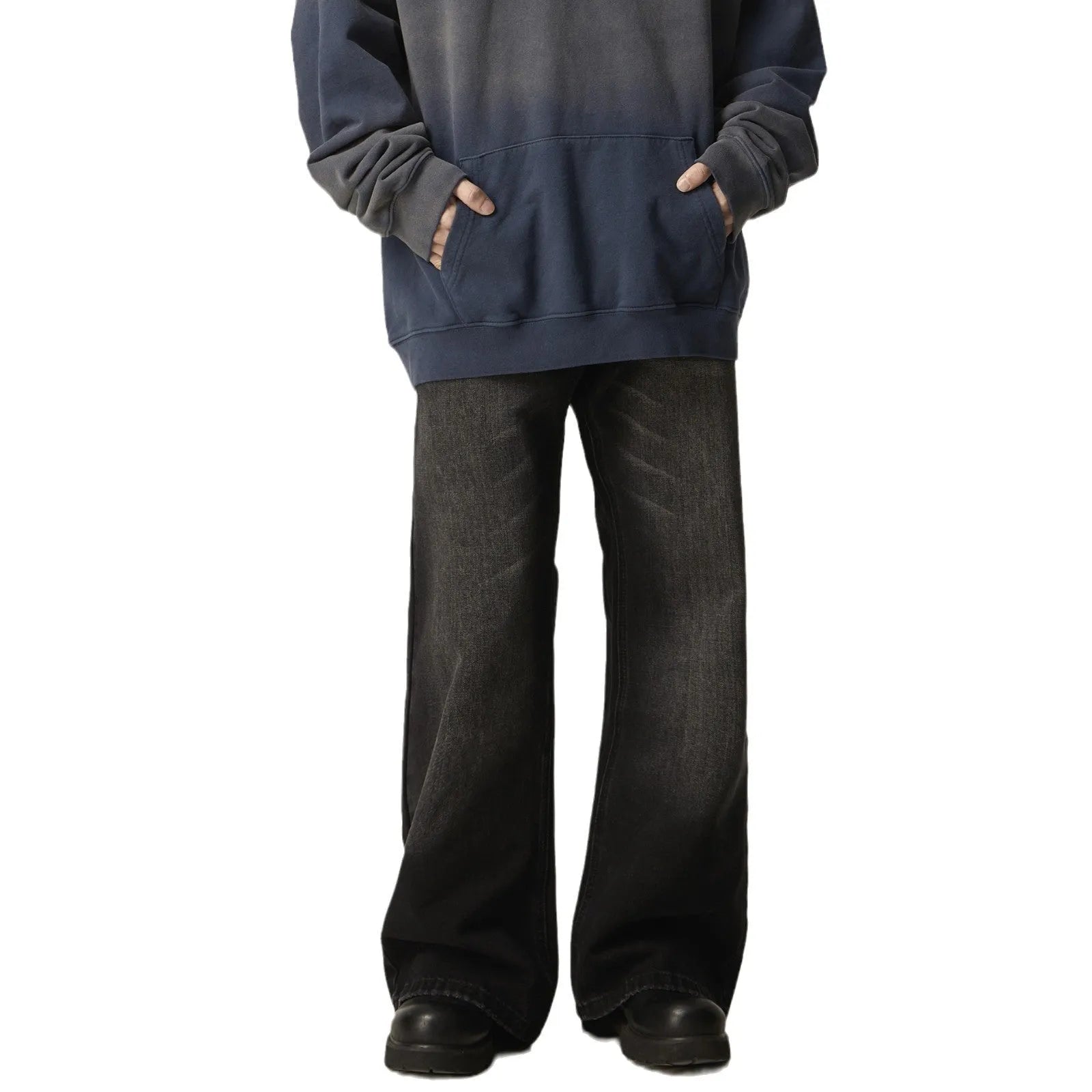 Man wearing black loose-fit straight-leg retro jeans in a casual setting.