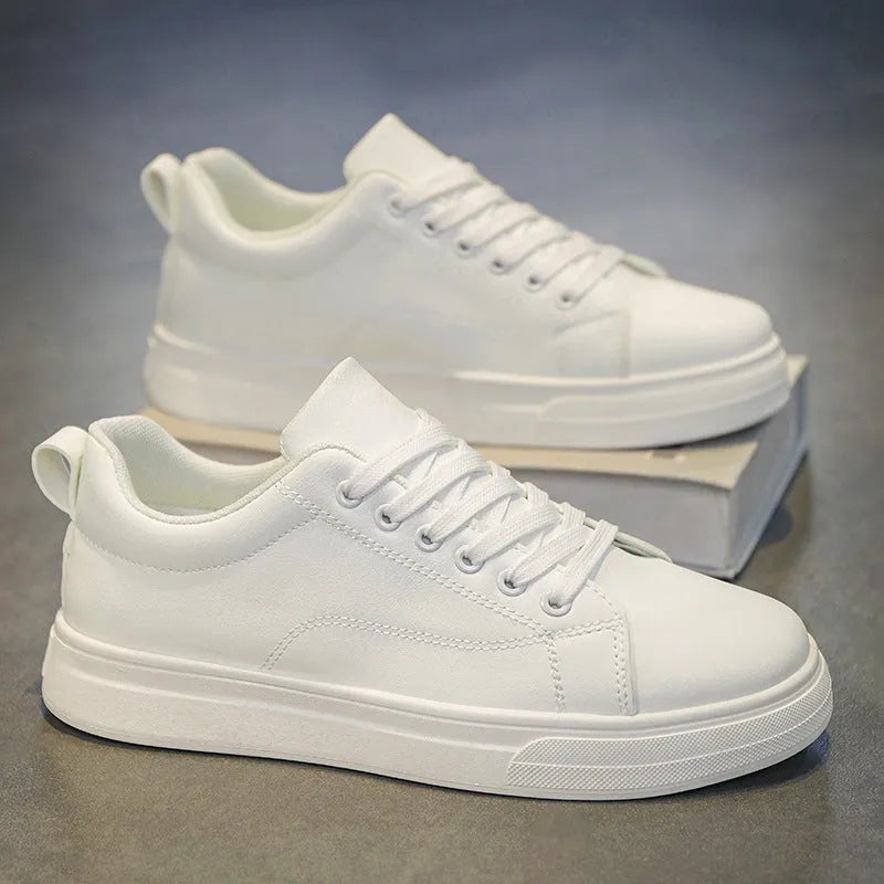 Men's white and black Korean-style low-top casual sneakers with round toe and flat heel.