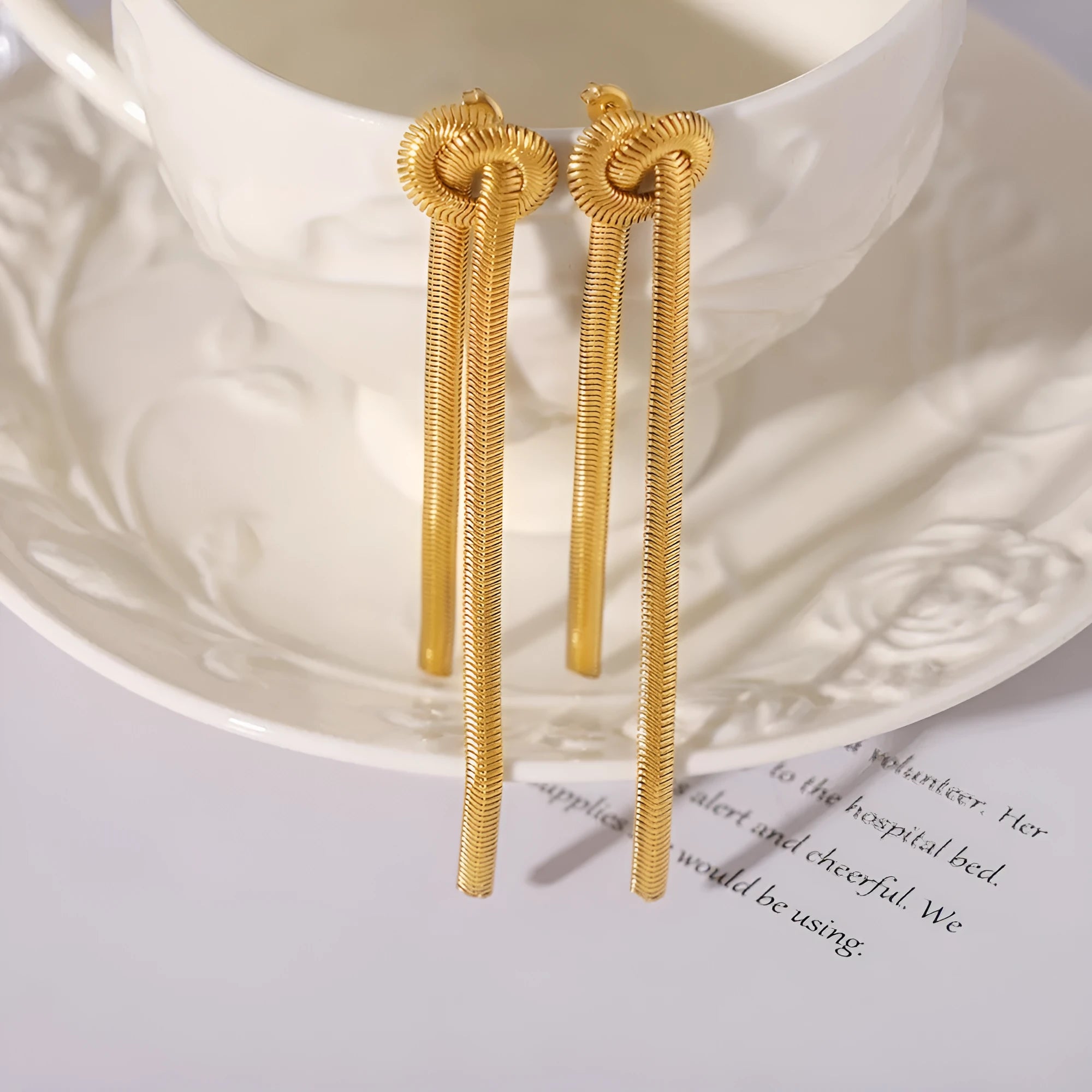 Gold electroplated titanium steel necklace and earrings set with snake chain and knotted tassel design