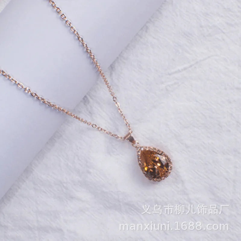 Rose gold plated drop pendant necklace with colourful rhinestones in a pink colour option.