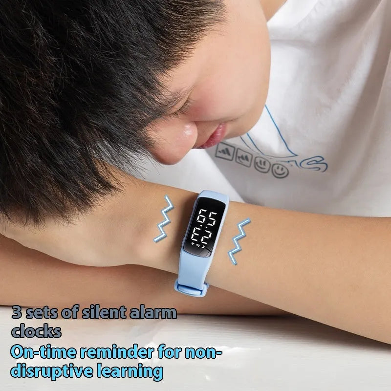 Vibration alarm clock watch with LED display on silicone strap showing multiple colour options