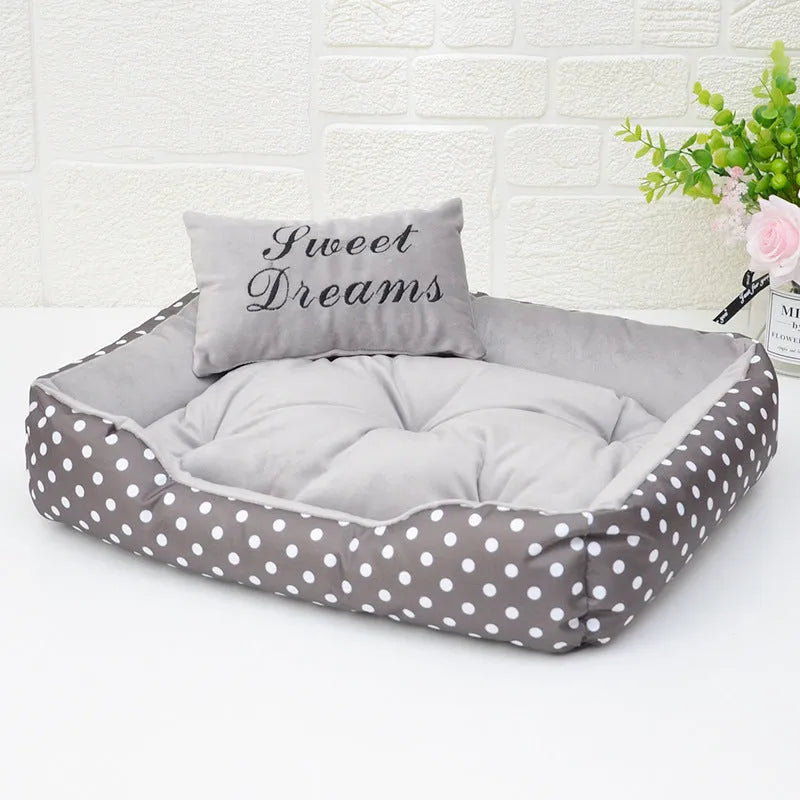 Polka dot print square dog bed with raised sides and a matching embroidered pillow in grey.