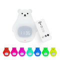 White silicone bear-shaped night light with timer and alarm clock functions on a bedside table.