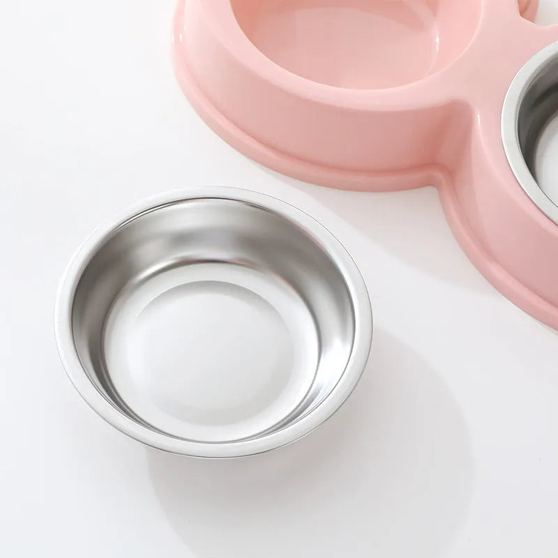 Stainless steel frog-shaped double bowl for pet food and water in blue, green, or pink.