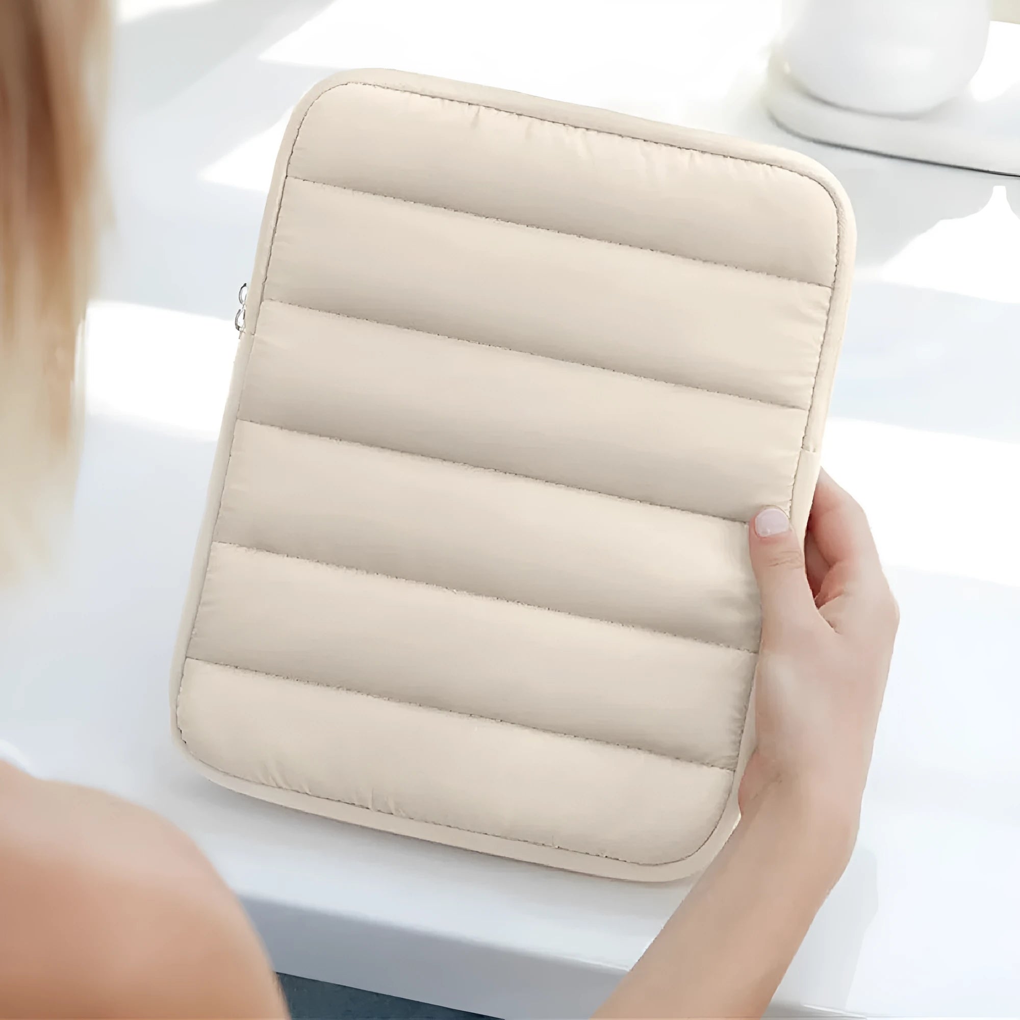 Black elastic laptop sleeve for 9.7-11 inch devices with puff cushioning and waterproof polyester